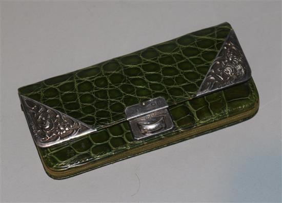 A late Victorian silver mounted crocodile skin purse.